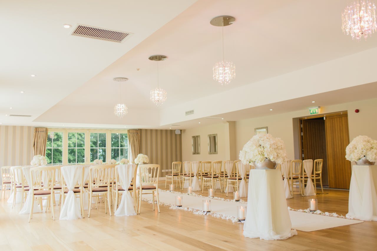 services-02 Brightly lit indoor wedding venue with elegant seating and floral decor, perfect for luxurious ceremonies.